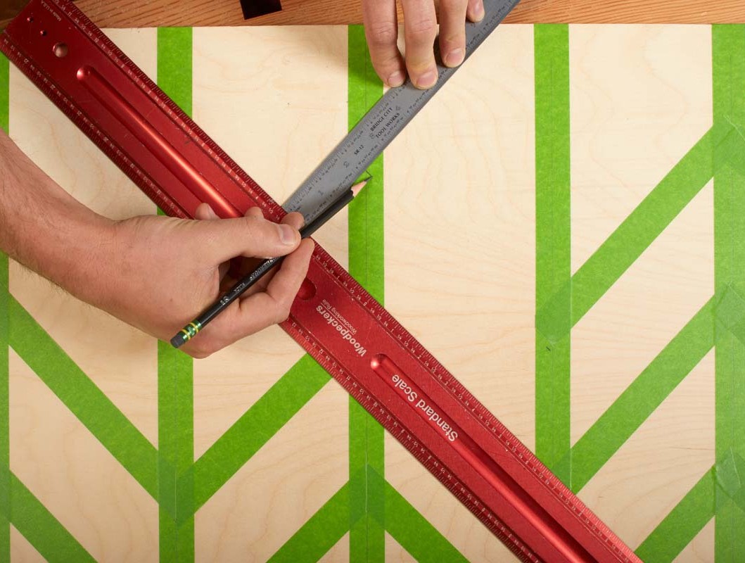 using 2 rulers and pencil to apply painters tape according to zig zag pattern