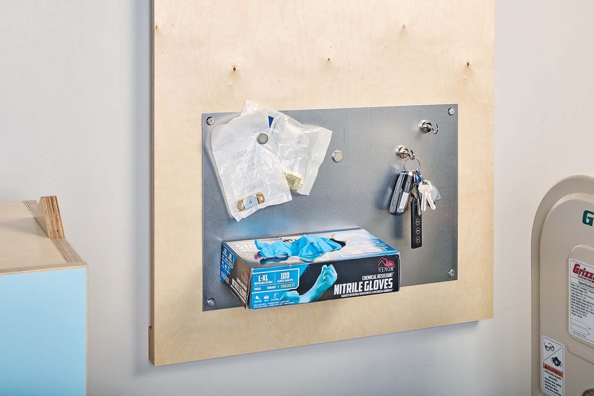 shop magnet board holding Nitrile gloves, small bags of hardware and keys