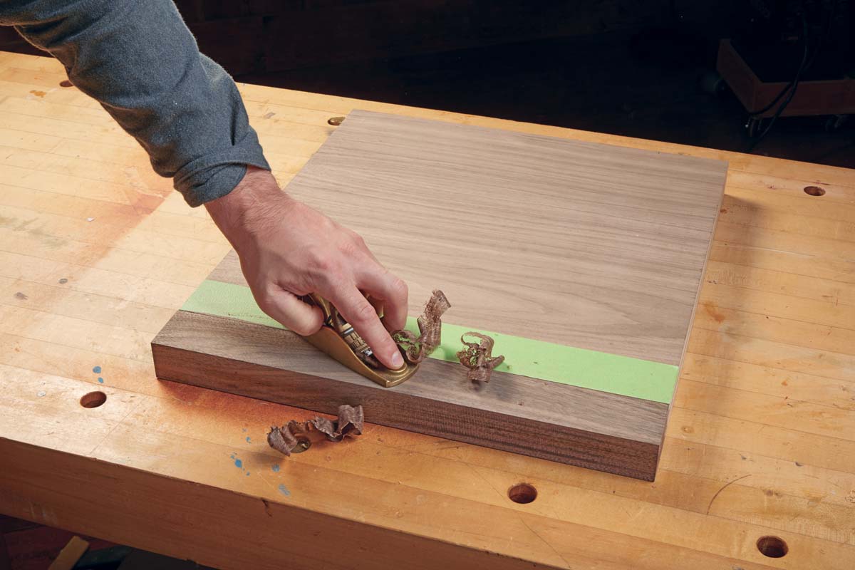 block plane being used smooth of plywood edging