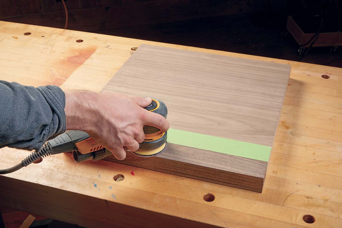 palm sander being used to polish/flush up plywood edging