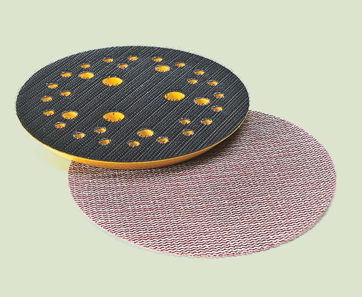 Abranet replacement pad (black and yellow) and abranet disc (pinkish brown)