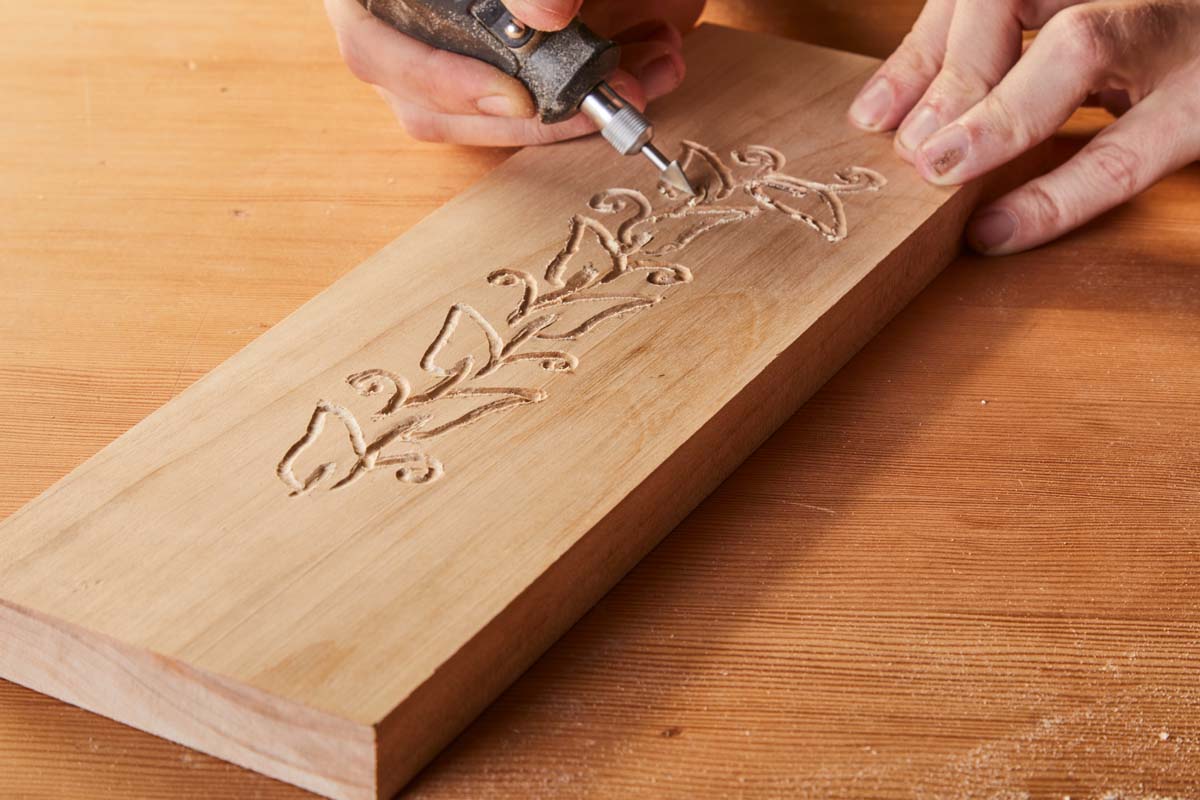 arrow shaped Dremel bit cutting vines into wood