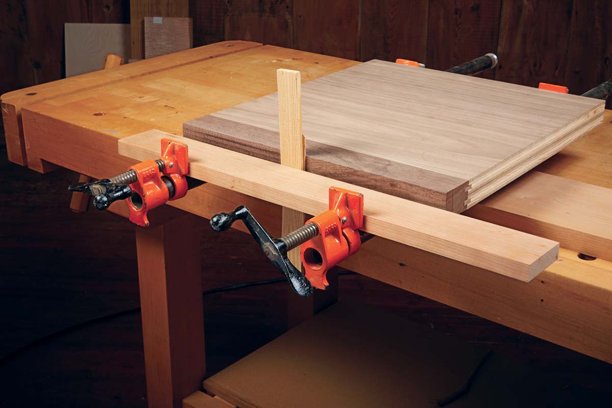 two wedges being used to clamp down edging project