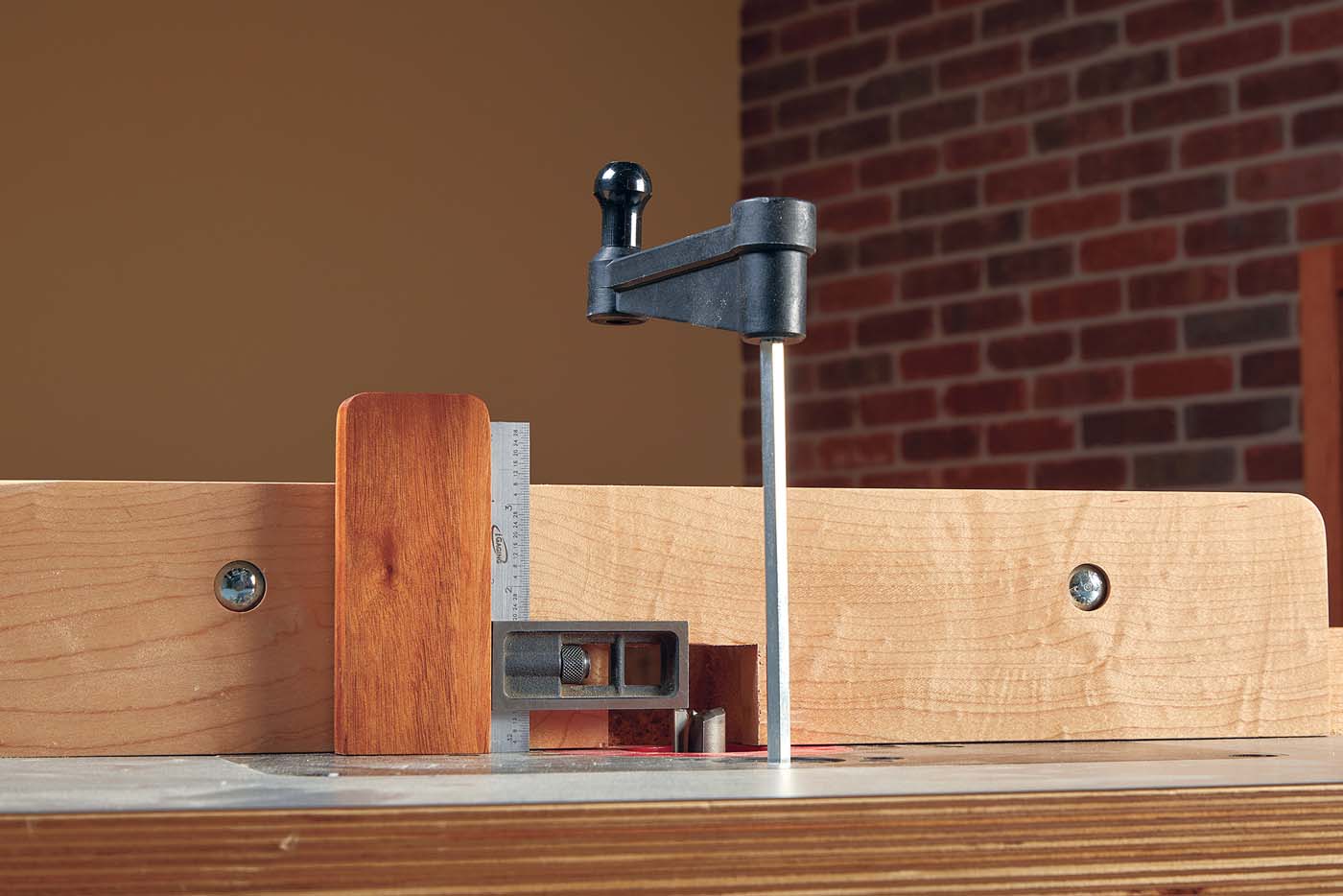 using a hardwood block and a magnet to set the height of your bit at the router table