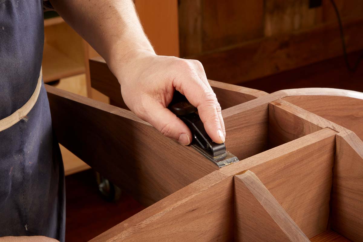 Chisel planes being used to trim glue ridges