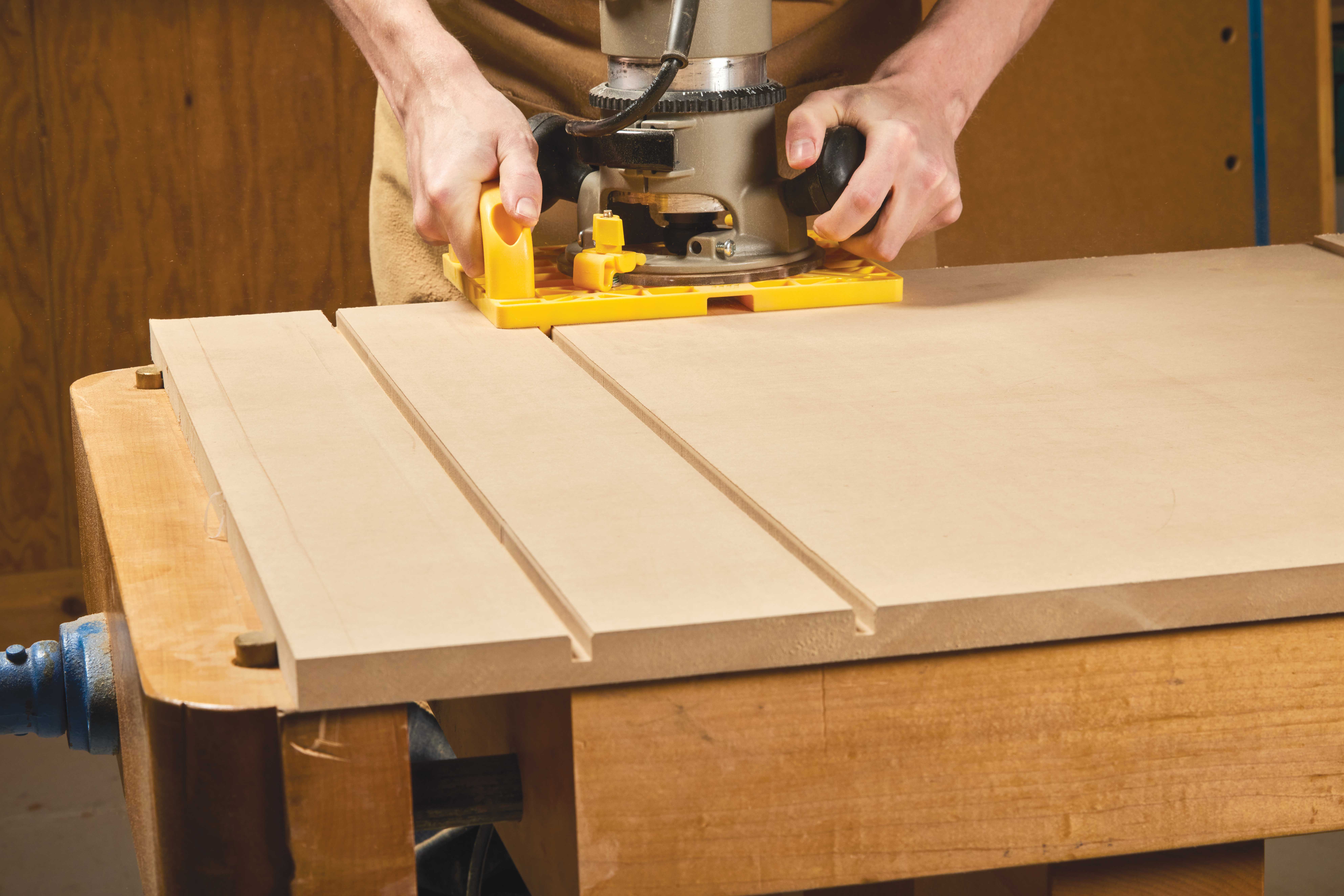 Image shows the router guide working against the board for the first cut