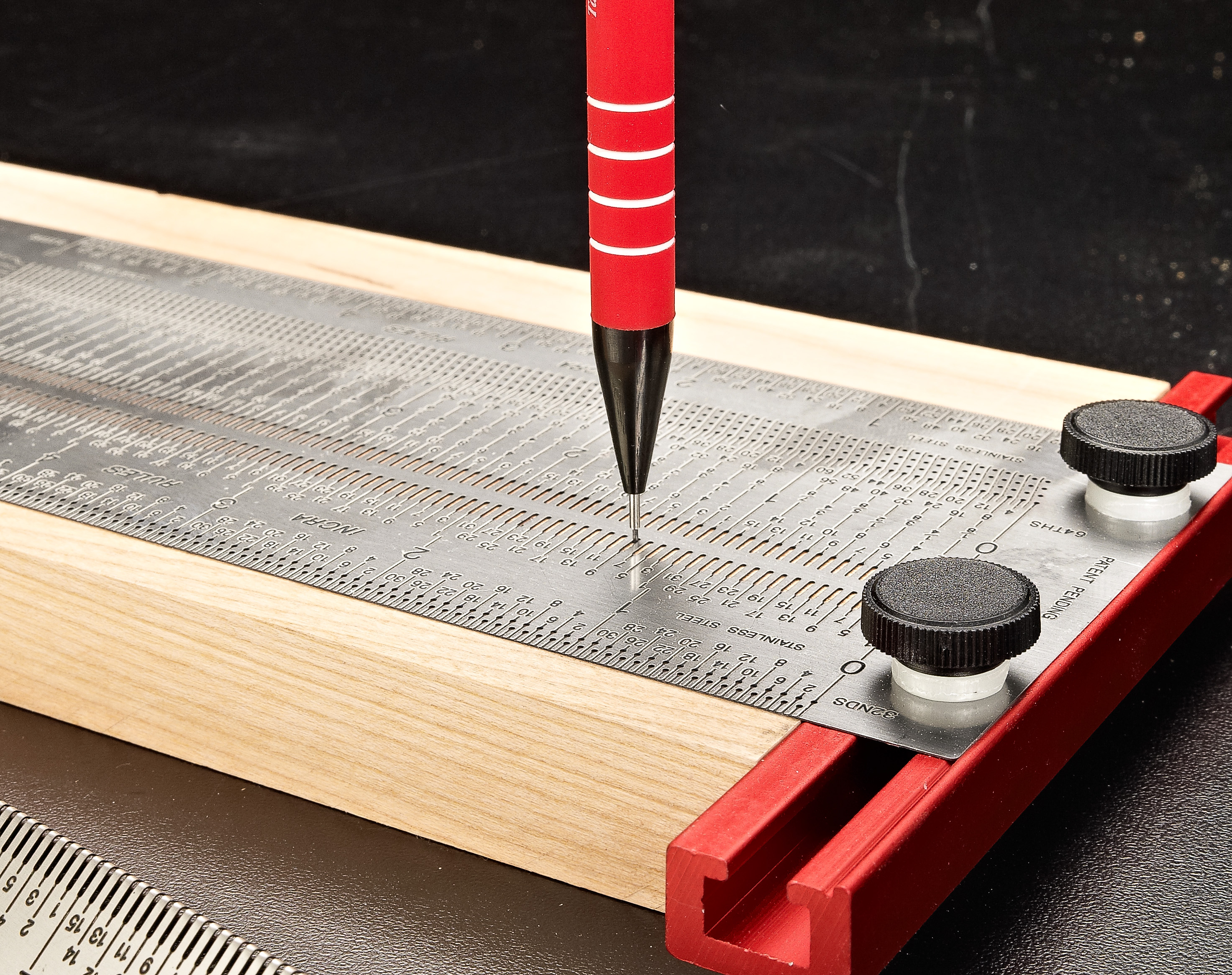using large steel rule to make pencil marks
