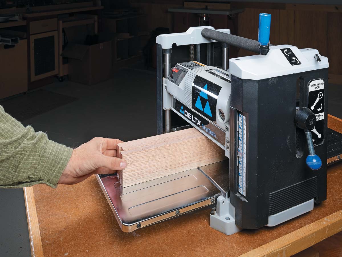 pusing wood into thickness planer