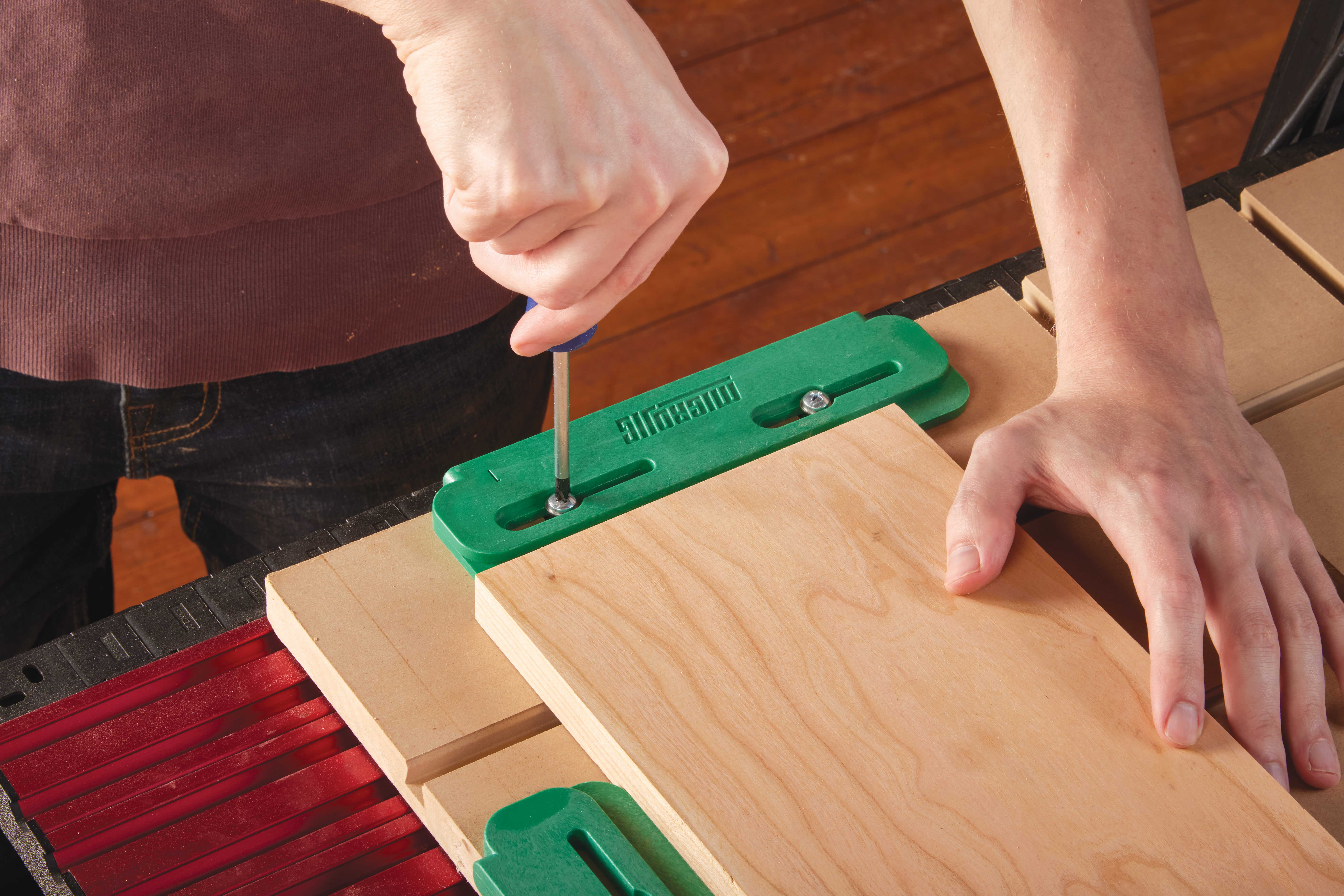 Using screwdriver to setup vibrant green CNC edge guides