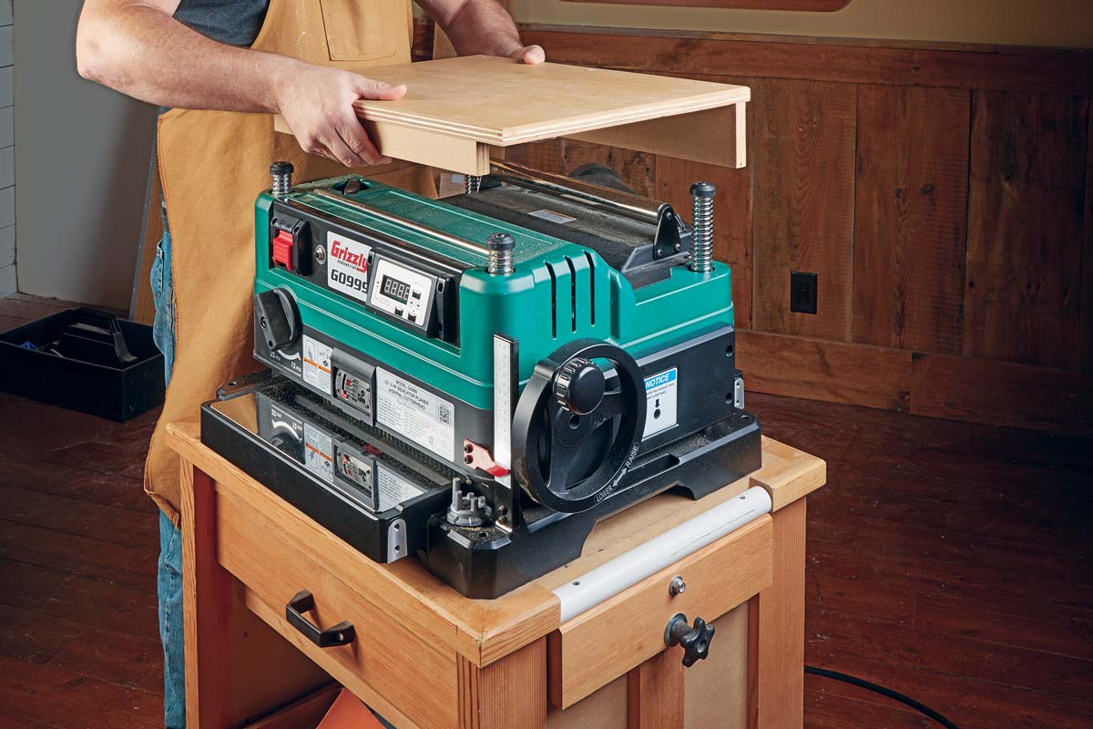 auxillary wood top/wood shelf being put on planer