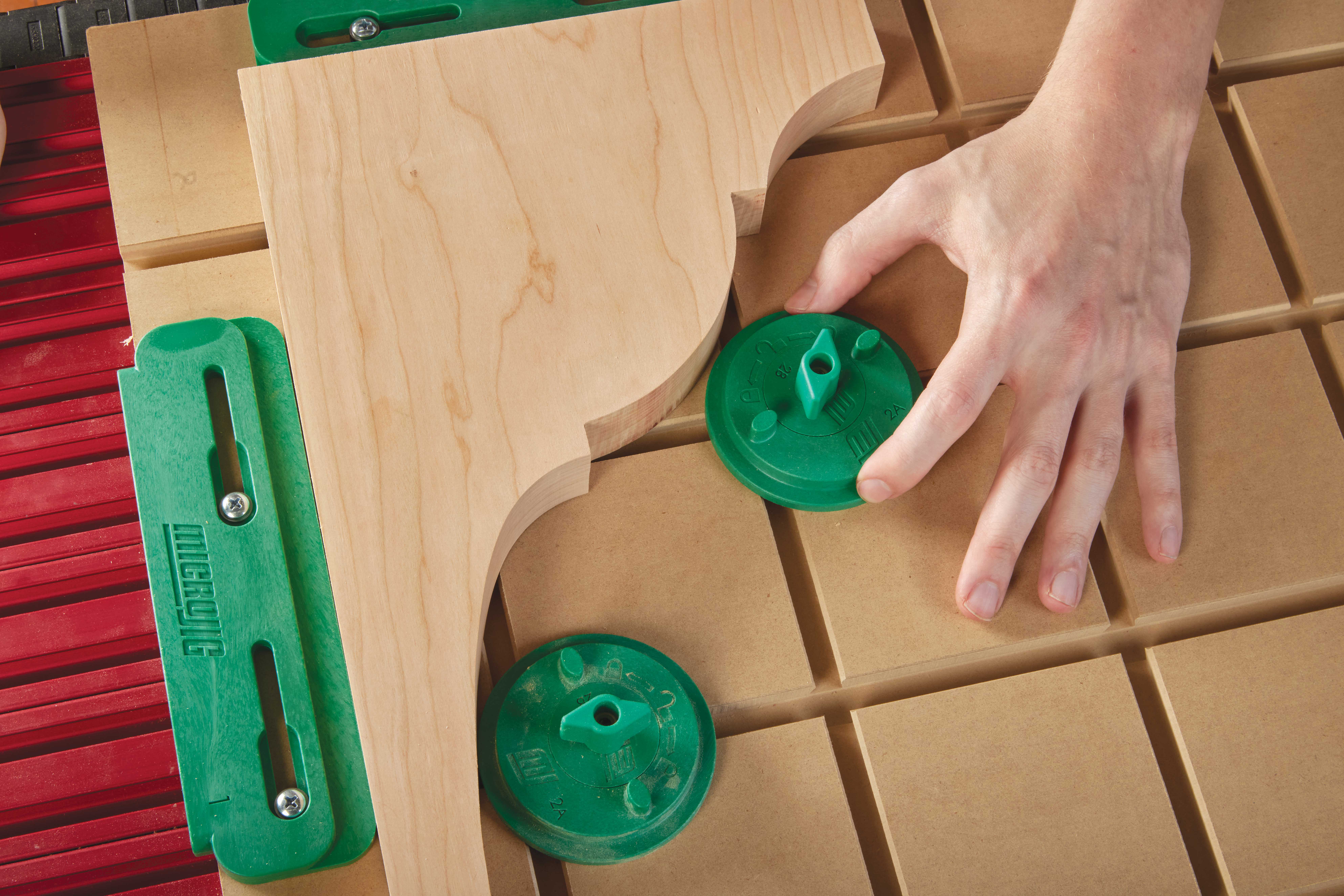 Twisting the clamps to lock in workpiece