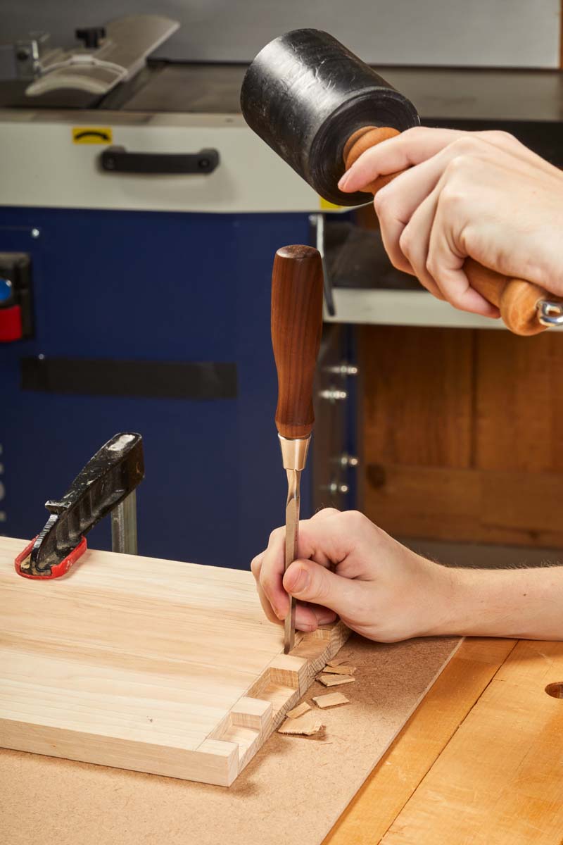 using hardboard to protect workbench while chiseling dovetails