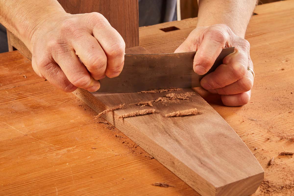 flexibile steel blade card scraper being used on workpiece