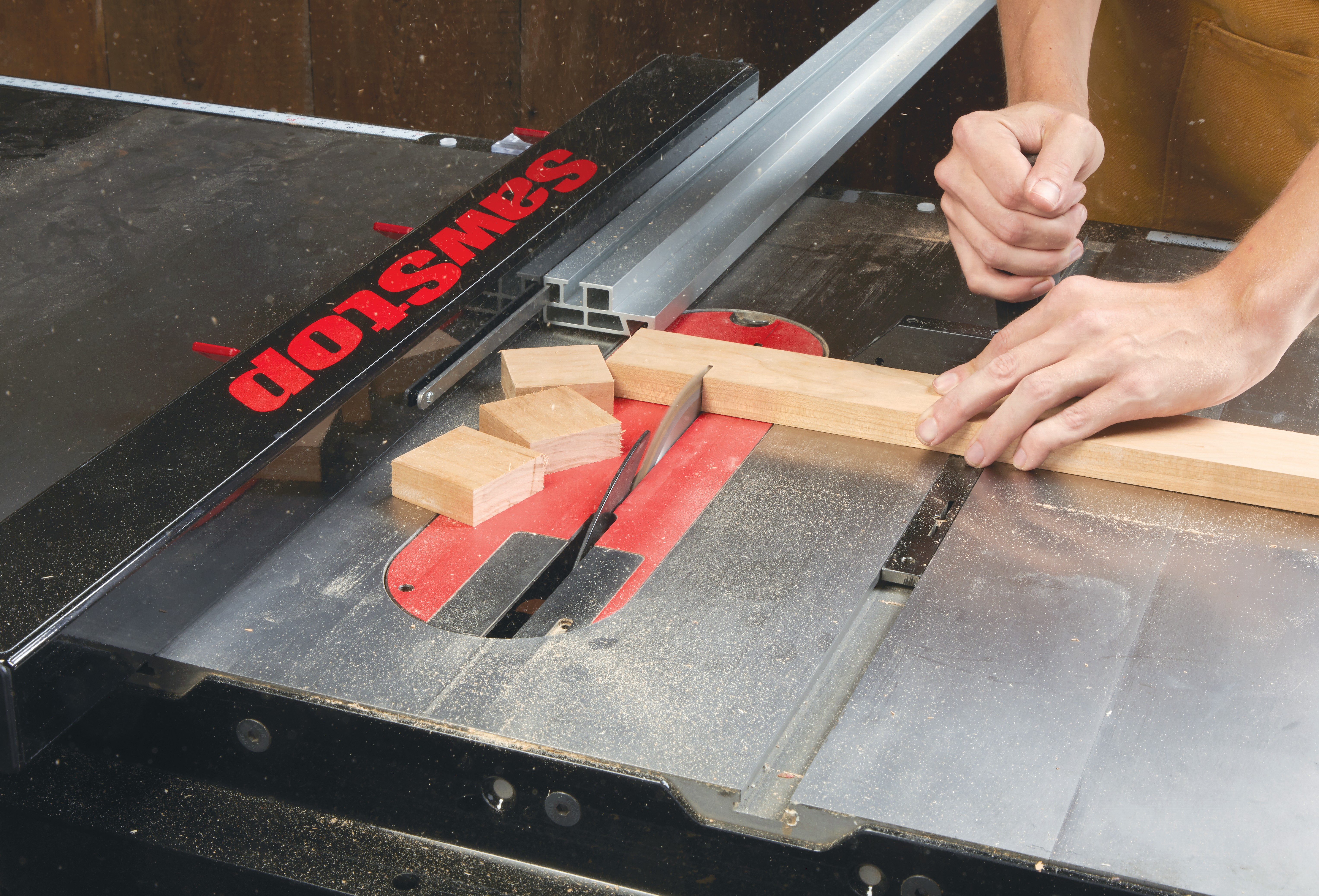 SawStop T-Glide Fence System being used on table saw to cut small wood pieces
