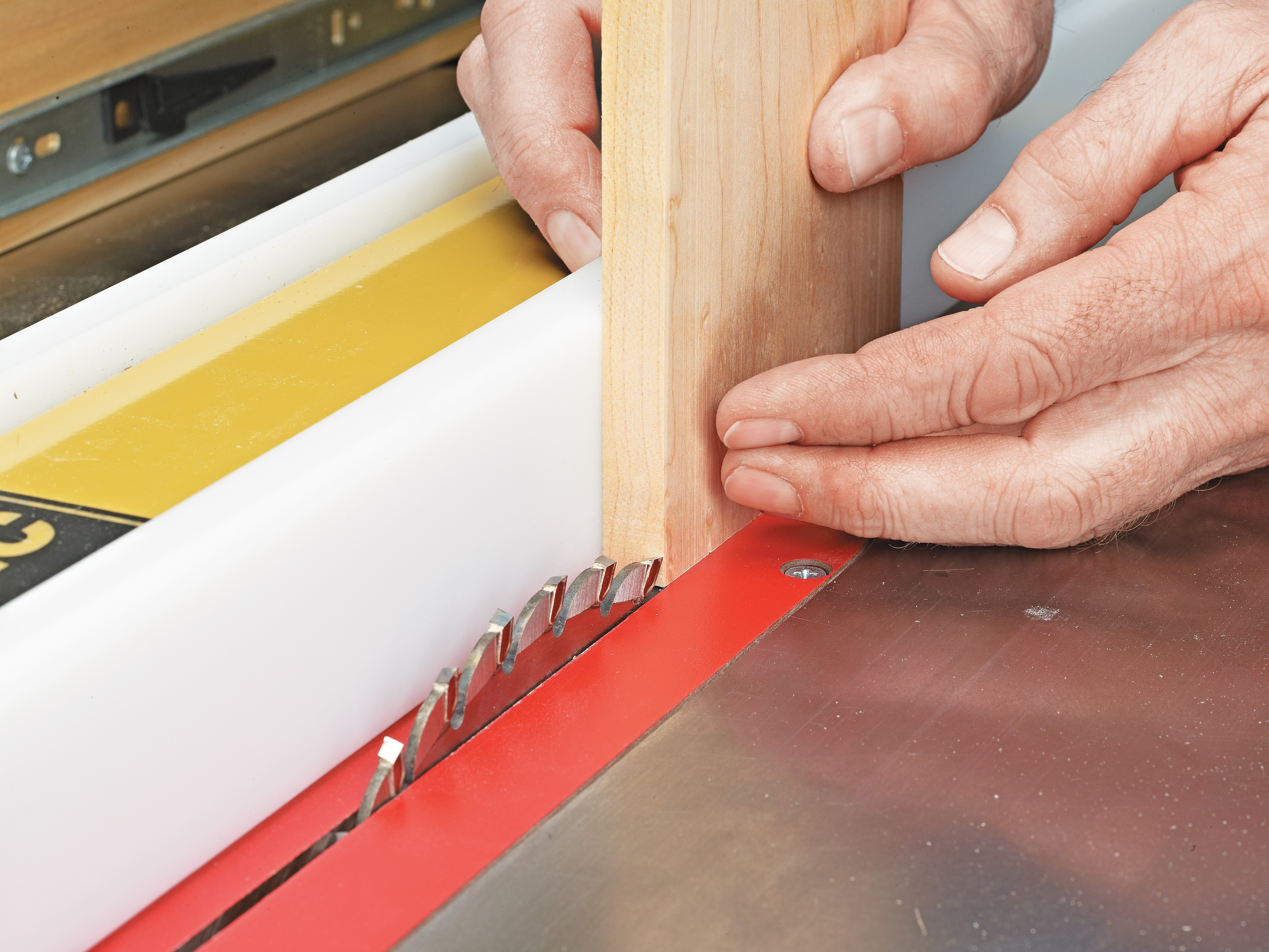 drawer front panel being cut with tablesaw