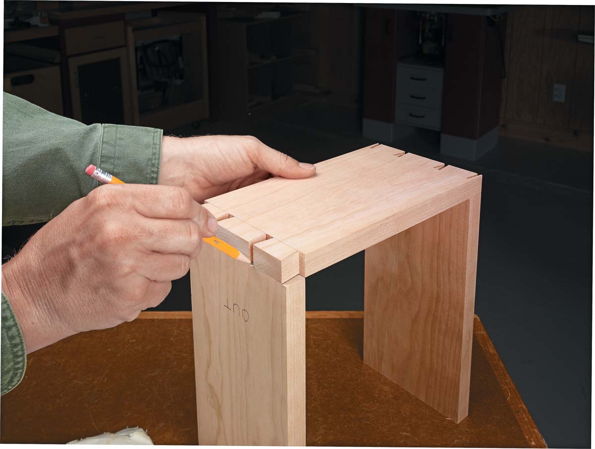 using pencils to trace sides of tails