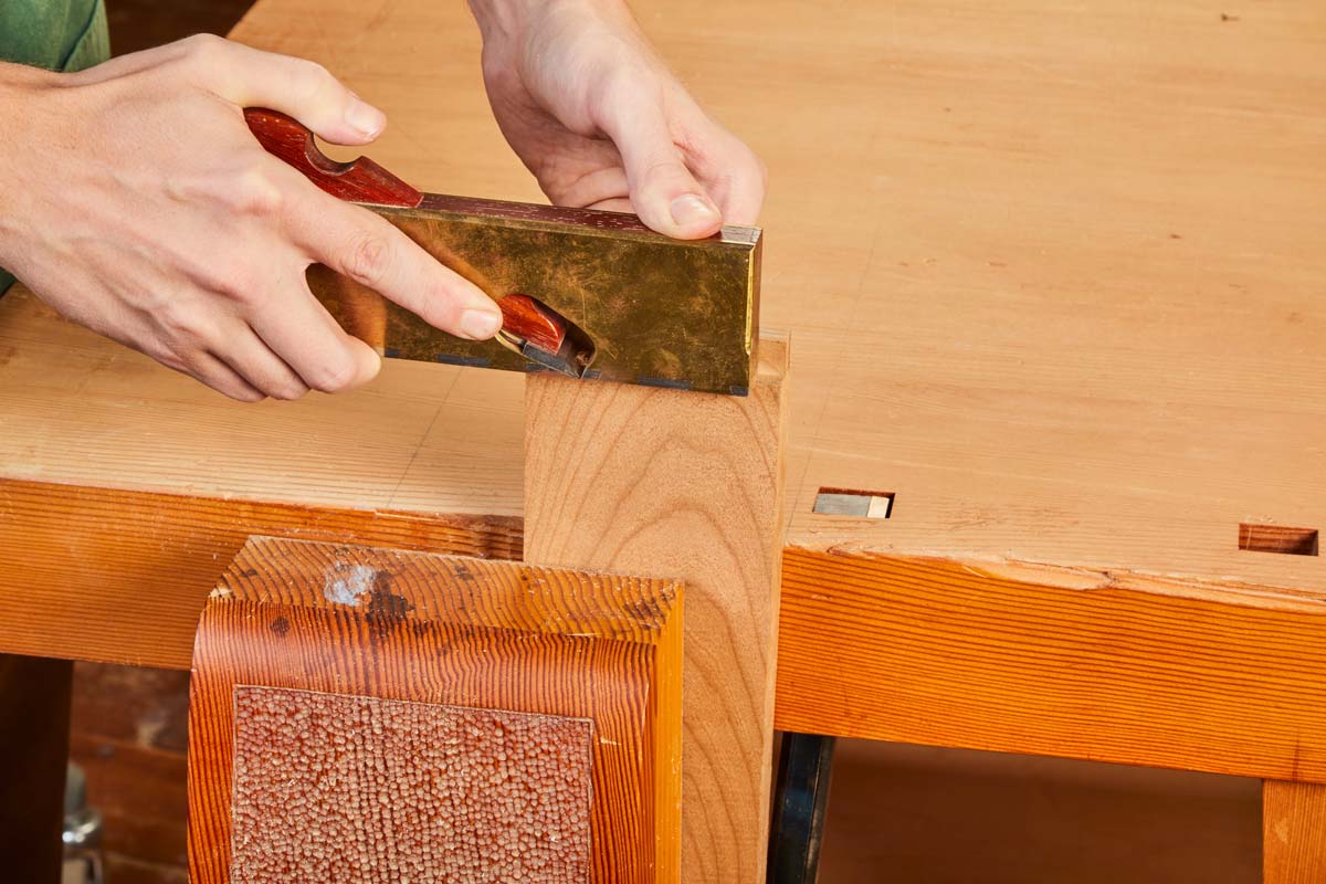 Shoulder Plane being used on edge of clamped wood piece for joinery