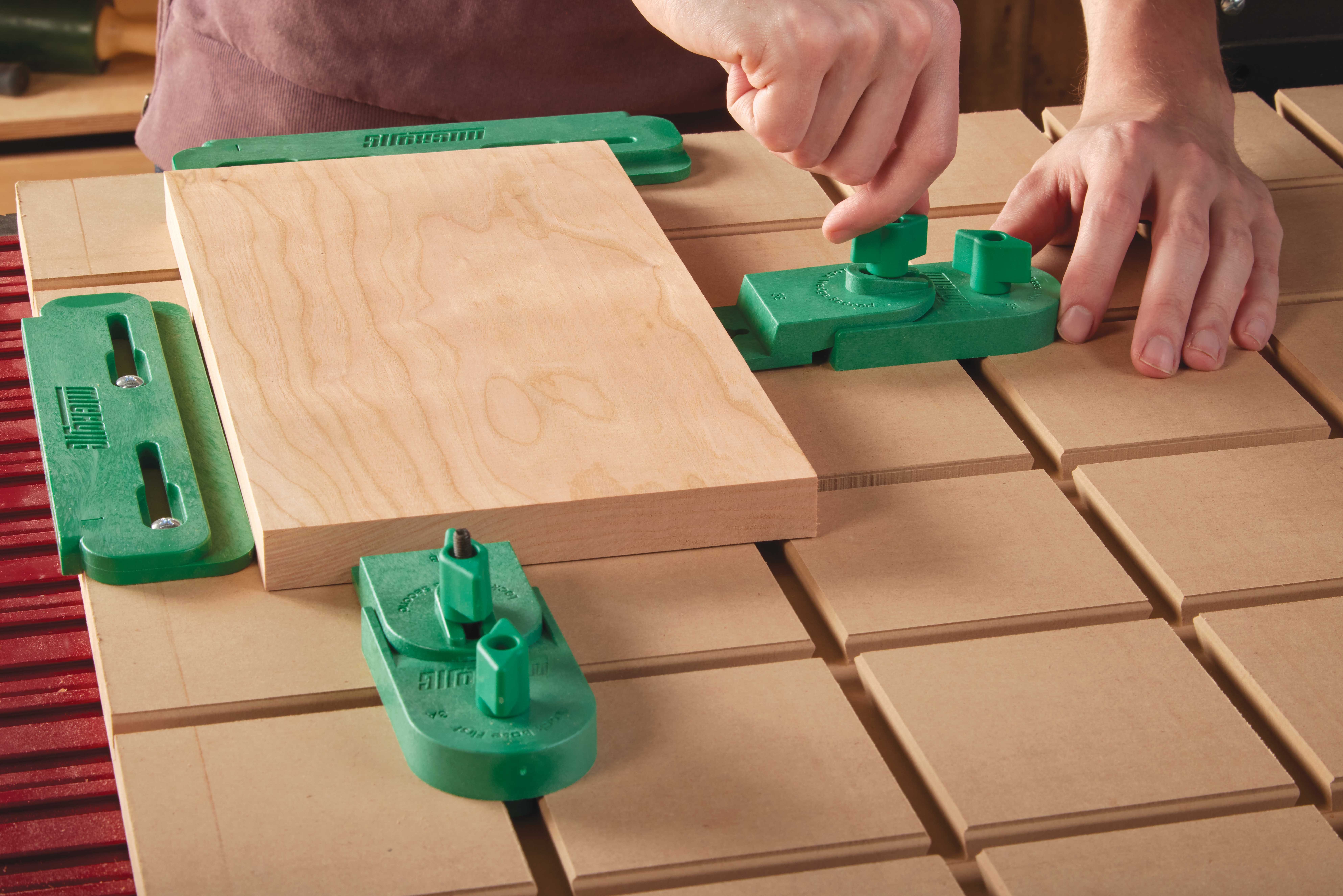 Attaching front and rear knobs to clamp workpiece