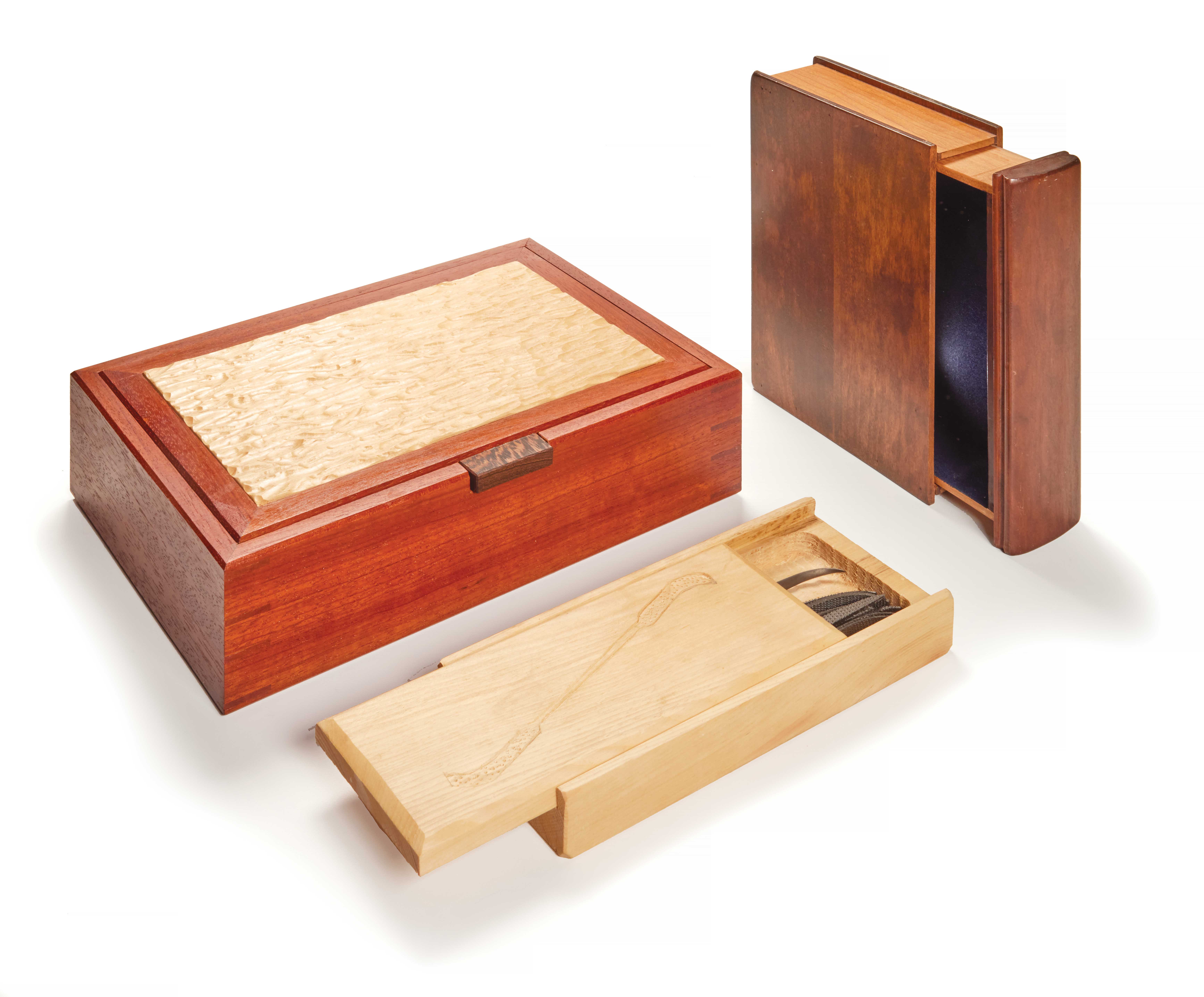 3 boxes with lids carved to interlock with the box. 2 are shaped to look like books.