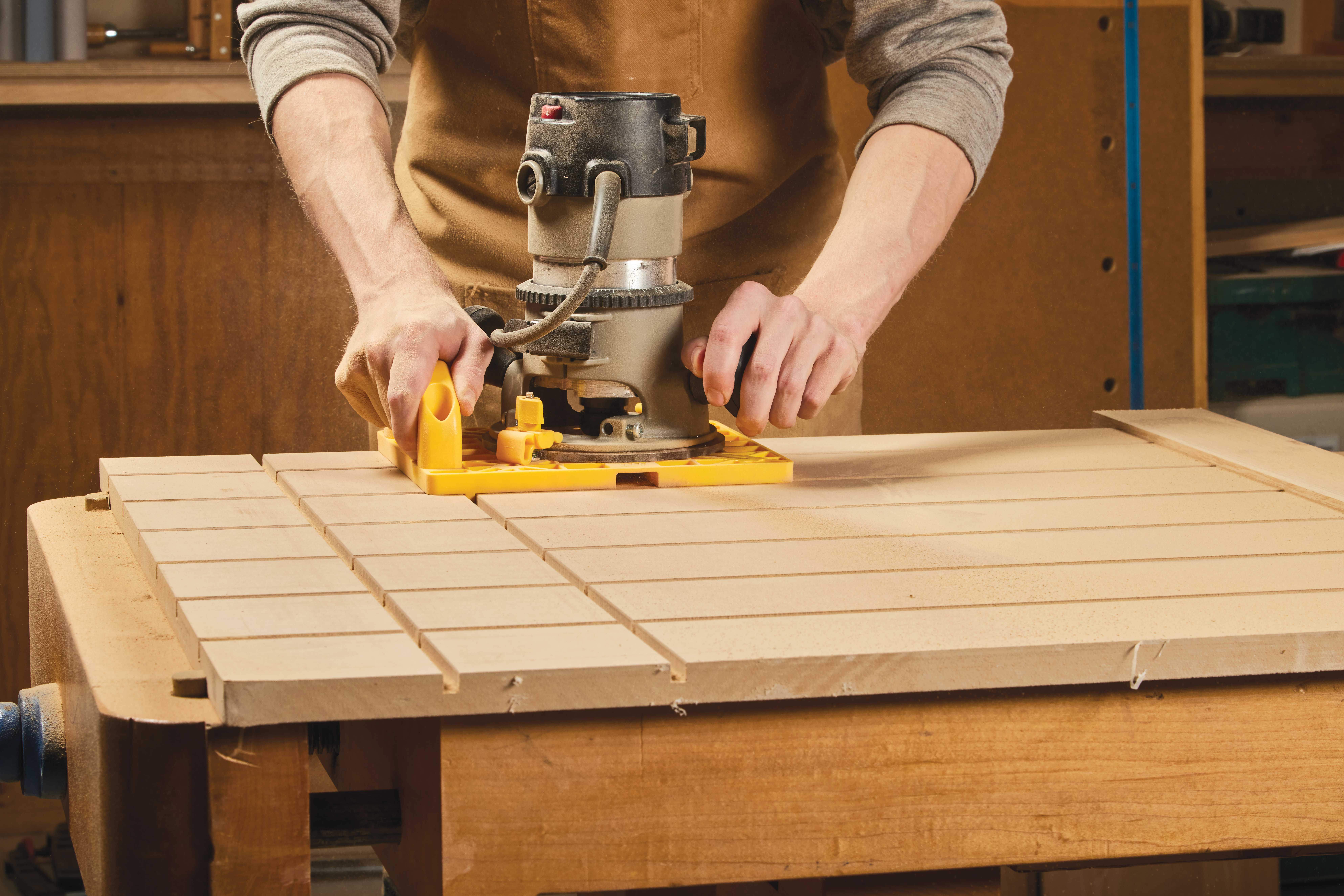 Image shows router making grid made by routing out slots with the relief bit