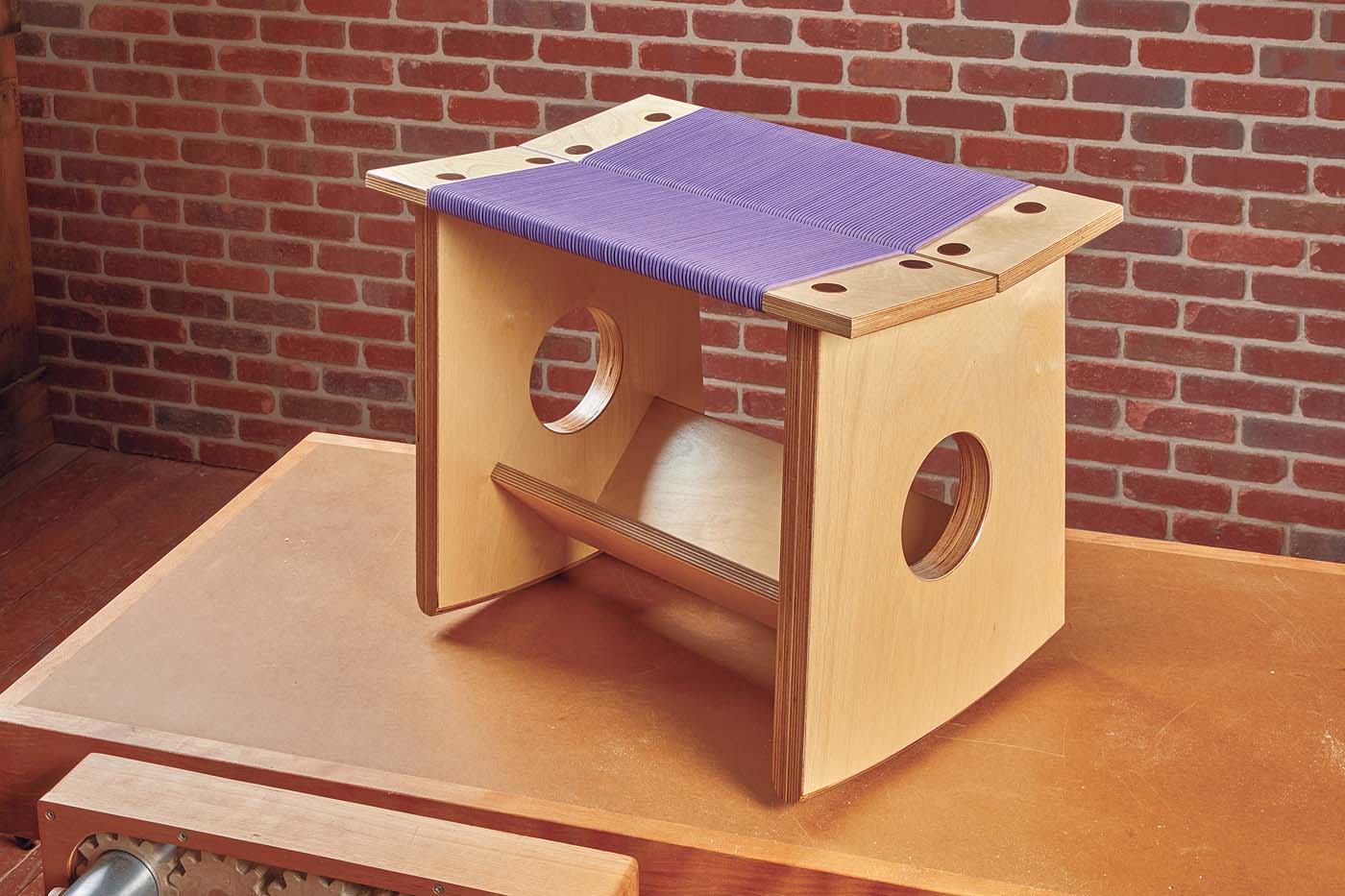 rocking stool with woven purple seat