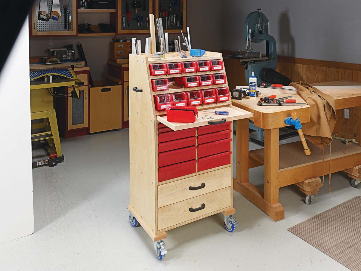 wood filling cabinet with red metal drawers and organizer bins on top