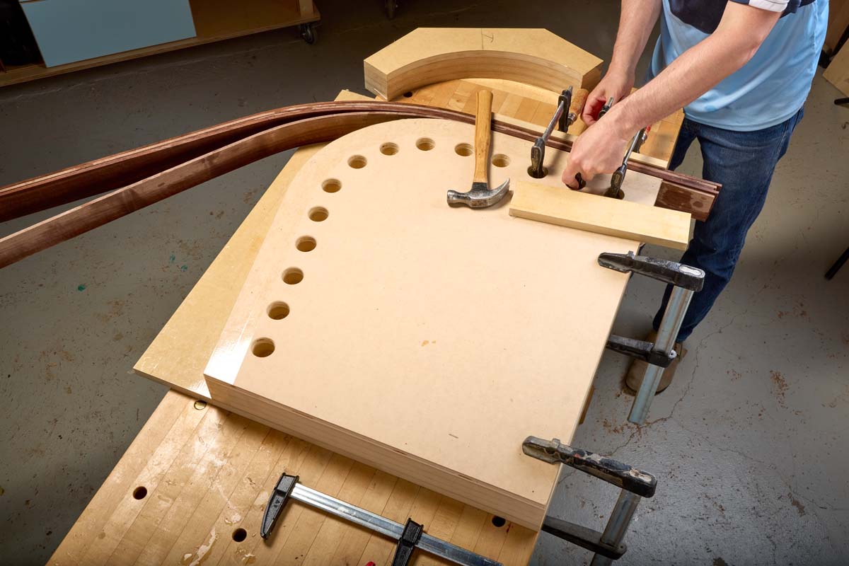 slowly adding clamps to lamination