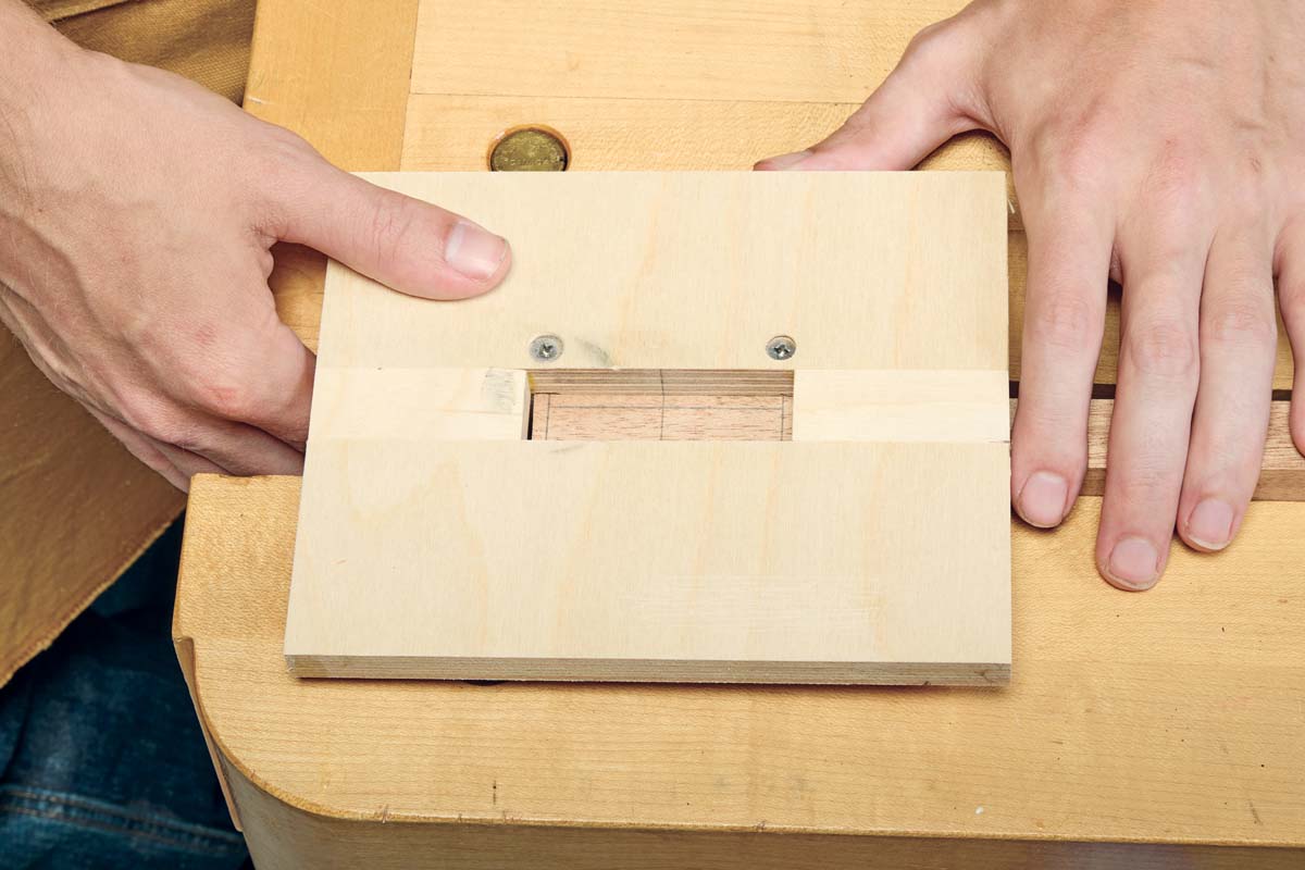 positioning mortise jig over where to cut mortise with pencil markings showing where to cut