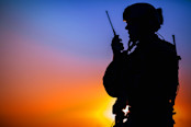 Solider Speaking into Walkie Talkie