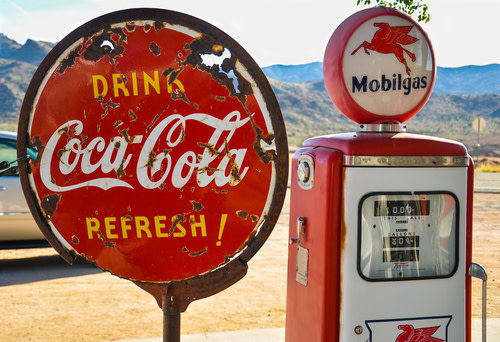 A rusty Coca Cola sign.