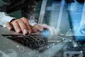 Man on laptop with transparent tech in foreground