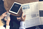 Investors reading newspaper