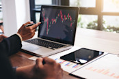 Business person pointing at a stock chart