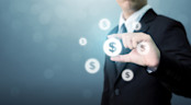 A man holding a dollar sign in a bubble.