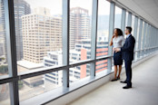 New Business Owners By Empty Office Window