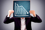 Man holding a chart showing downward trend