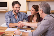 Happy man shaking hands whit his finacial advisor