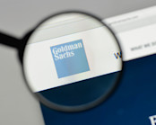 Goldman Sachs logo under magnifying glass