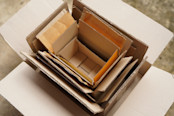 Top view of used shipping cardboard boxes in multiple sizes stacked on each other