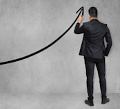 Businessman Drawing Uptrends Arrow