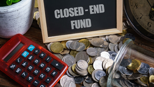 Closed-end fund on a chalboard with a calculator and coins