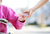 Woman joining hands with her caretaker