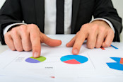 Businessman comparing two charts