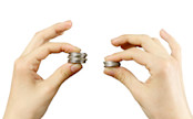 Two hands holding piles of coins