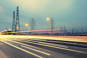 High-voltage tower sky background,besides the highway