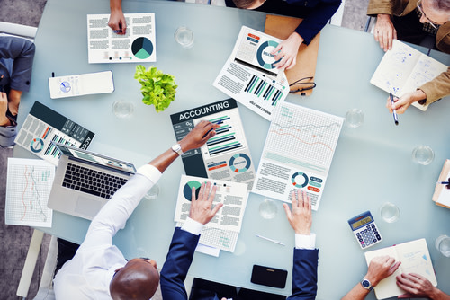 A meeting with charts and graphs in the table.