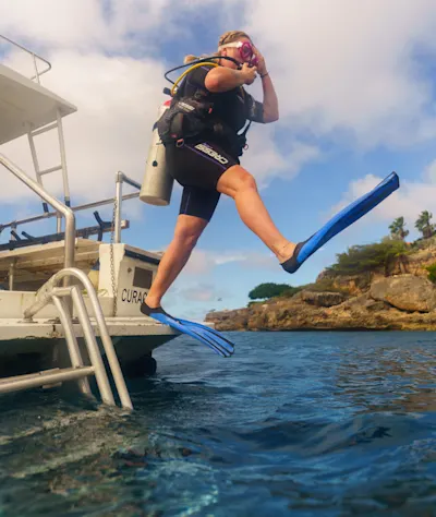 Diver stepping off boat