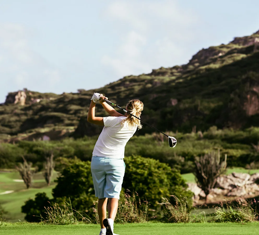A woman playing golf.