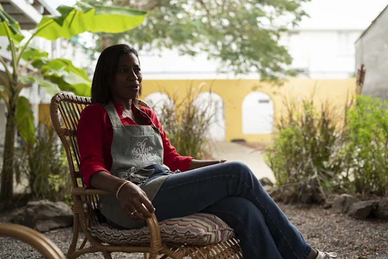 Korra sitting in a chair in the Fleur de Marie garden.