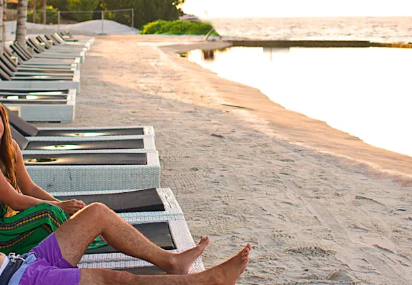 A couple lounging on the beach.